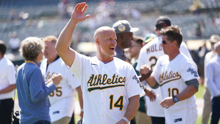 Aug 28, 2022; Oakland, California, USA; Former Oakland Athletics player Mark Ellis waves to fans before the start of the 20th-anniversary celebration for the Athletics team that won 20 consecutive games in 2002 at RingCentral Coliseum. Mandatory Credit: Cary Edmondson-Imagn Images