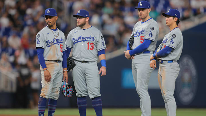 May 5, 2025; Miami, Florida, USA; Los Angeles Dodgers shortstop Mookie Betts (50), third baseman Max Muncy (13), first baseman Freddie Freeman (5), and second baseman Hyeseong Kim (6) look on during a pitching change against the Miami Marlins in the sixth inning at loanDepot Park. Mandatory Credit: Sam Navarro-Imagn Images May 5, 2025; Miami, Florida, USA; Los Angeles Dodgers shortstop Mookie Betts (50), third baseman Max Muncy (13), first baseman Freddie Freeman (5), and second baseman Hyeseong Kim (6) look on during a pitching change against the Miami Marlins in the sixth inning at loanDepot Park. Mandatory Credit: Sam Navarro-Imagn Images