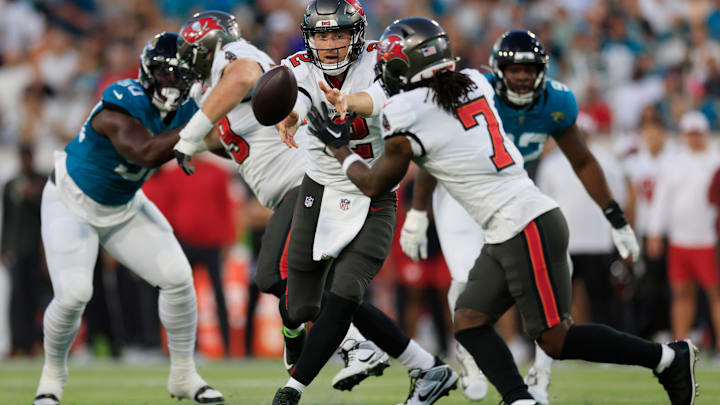 Tampa Bay Buccaneers quarterback Kyle Trask (2) pitches the ball to running back Bucky Irving (7) during the first quarter of a preseason NFL football game Saturday, Aug. 17, 2024 at EverBank Stadium in Jacksonville, Fla. The Jacksonville Jaguars defeated the Tampa Bay Buccaneers 20-7. [Corey Perrine/Florida Times-Union]