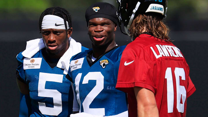 Jacksonville Jaguars wide receiver Travis Hunter (12) talks with quarterback Trevor Lawrence (16) as wide receiver Dyami Brown (5) looks on after an NFL training camp session at the Miller Electric Center, Sunday, Aug. 3, 2025, in Jacksonville, Fla. [Corey Perrine/Florida Times-Union]