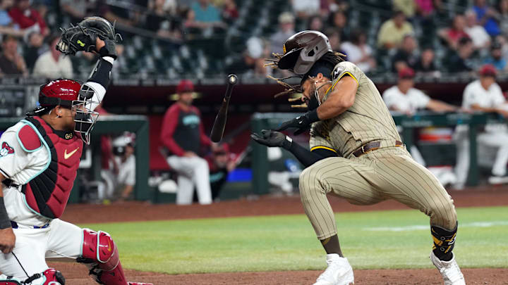 May 3, 2024; Phoenix, Arizona, USA; San Diego Padres outfielder Fernando Tatis Jr. (23) dodges a pitch from Scott McGough May 3, 2024; Phoenix, Arizona, USA; San Diego Padres outfielder Fernando Tatis Jr. (23) dodges a pitch from Scott McGough