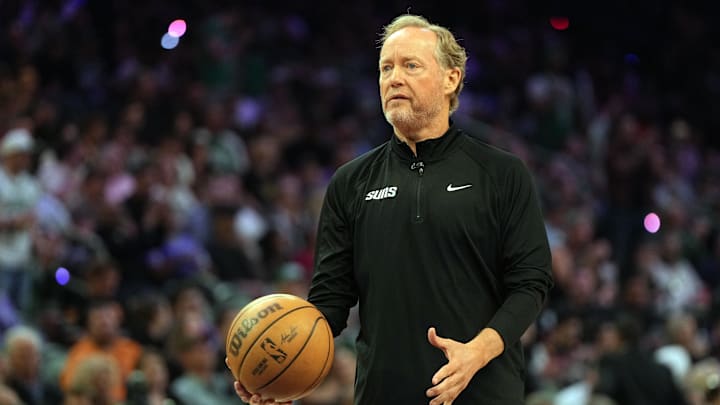 Mar 26, 2025; Phoenix, Arizona, USA; Phoenix Suns head coach Mike Budenholzer catches the ball against the Boston Celtics during the first half at Footprint Center. Mandatory Credit: Rick Scuteri-Imagn Images Mar 26, 2025; Phoenix, Arizona, USA; Phoenix Suns head coach Mike Budenholzer catches the ball against the Boston Celtics during the first half at Footprint Center. Mandatory Credit: Rick Scuteri-Imagn Images