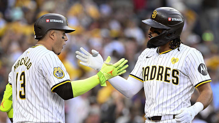 Oct 1, 2024; San Diego, California, USA; San Diego Padres outfielder Fernando Tatis Jr. (23) reacts with third base Manny Machado (13) after hitting a two run home run against the Atlanta Braves during the first inning in game one of the Wildcard round for the 2024 MLB Playoffs at Petco Park. Mandatory Credit: Denis Poroy-Imagn Images