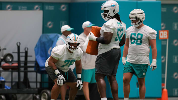 Miami Dolphins offensive tackle Larry Borom (79) works with offensive tackle Patrick Paul (52) during training camp at Baptist Health Training Complex. Miami Dolphins offensive tackle Larry Borom (79) works with offensive tackle Patrick Paul (52) during training camp at Baptist Health Training Complex.