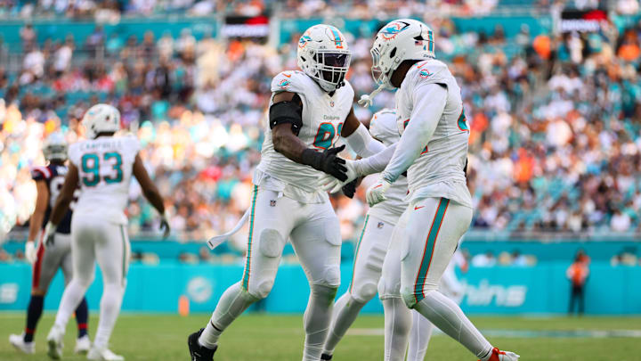 Miami Dolphins linebacker Emmanuel Ogbah (91) celebrates with linebacker Chop Robinson (44) after a play against the New England Patriots during the second quarter at Hard Rock Stadium. 