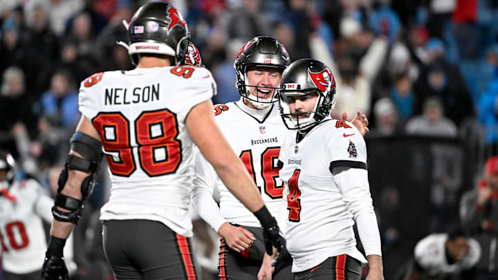 Dec 1, 2024; Charlotte, North Carolina, USA; Tampa Bay Buccaneers place kicker Chase McLaughlin (4) celebrates with linebacker Anthony Nelson (98) and punter Trenton Gill (16) after kicking the game winning field goal in overtime at Bank of America Stadium. Mandatory Credit: Bob Donnan-Imagn Images