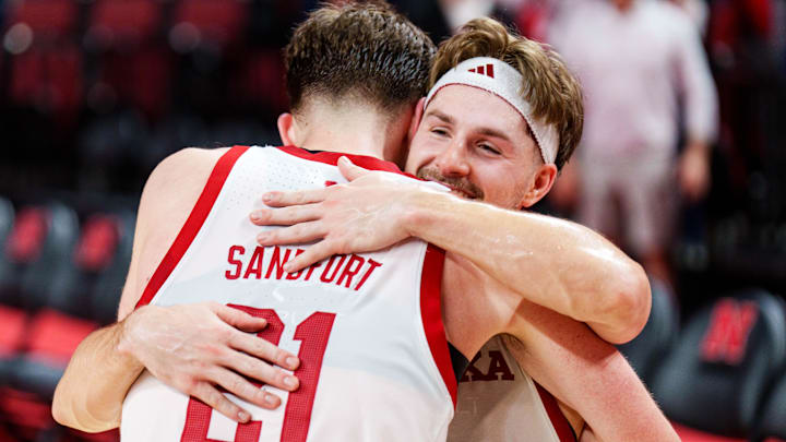 Sam Hoiberg and Pryce Sandfort embrace after defeating the Iowa Hawkeyes. 