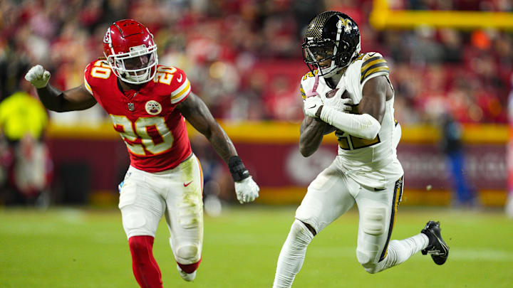 Oct 7, 2024; Kansas City, Missouri, USA; New Orleans Saints wide receiver Rashid Shaheed (22) runs with the ball  against Kansas City Chiefs safety Justin Reid (20) during the second half at GEHA Field at Arrowhead Stadium. Mandatory Credit: Jay Biggerstaff-Imagn Images