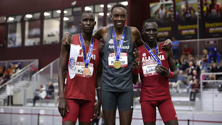 Alabama track runners Dismusk Lokira and Victor Kiprop pose with medals at the 2025 SEC Indoor Championship