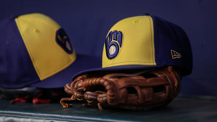 Jul 28, 2023; Atlanta, Georgia, USA; A detailed view of a Milwaukee Brewers hat and glove on the bench against the Atlanta Braves in the second inning at Truist Park. Mandatory Credit: Brett Davis-Imagn Images