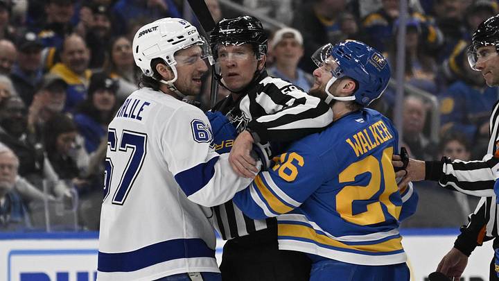 Jan 16, 2026; St. Louis, Missouri, USA; Tampa Bay Lightning defenseman Declan Carlile (67) and St. Louis Blues left wing Nathan Walker (26) get physical during the first period at Enterprise Center. Mandatory Credit: Jeff Le-Imagn Images