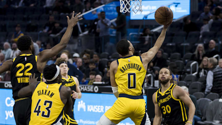 March 22, 2024 - San Francisco, California, USA: Indiana Pacers guard Tyrese Haliburton (0) shoots in front of Golden State Warriors guard Stephen Curry (30) during the second half at Chase Center. Mandatory Credit: John Hefti-Imagn Images
