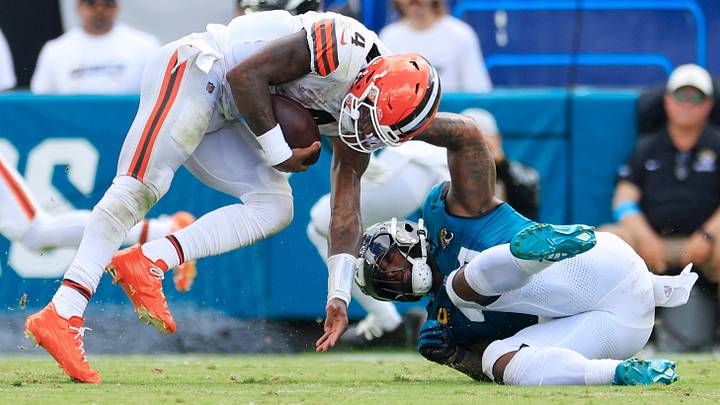 Cleveland Browns quarterback Deshaun Watson (4) is tackled by Jacksonville Jaguars defensive end Josh Hines-Allen (41) during the fourth quarter of an NFL football matchup at EverBank Stadium on Sunday, Sept. 13, 2026, in Jacksonville, Fla. The Jaguars defeated the Browns 34-10. [Corey Perrine/Florida Times-Union]