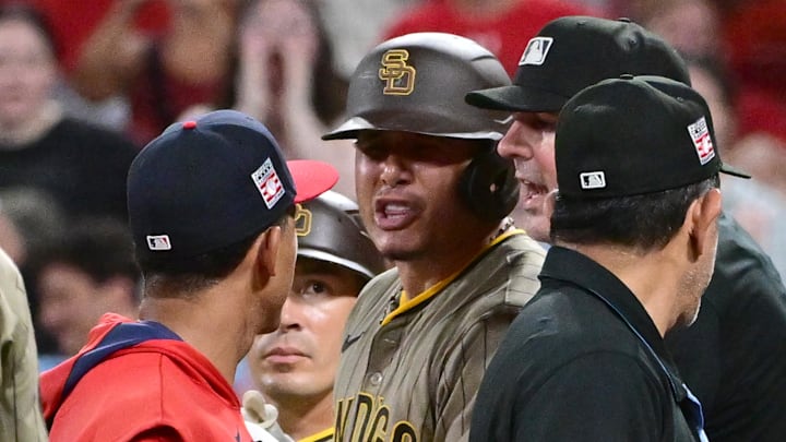 Jul 26, 2025; St. Louis, Missouri, USA; San Diego Padres third baseman Manny Machado (13, right) exchanges words with St. Louis Cardinals coach Jon Jay (19) which lead to players from both teams cleared the dugouts in the ninth inning at Busch Stadium. Mandatory Credit: Tim Vizer-Imagn Images