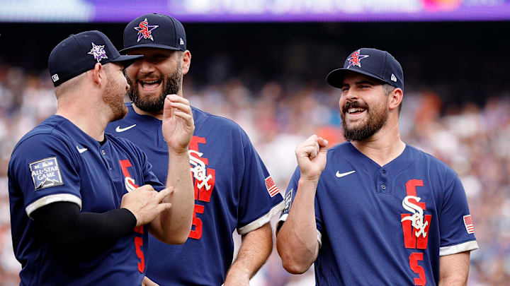 American League pitcher Carlos Rodon of the Chicago White Sox (right) laughs as he talks with pitcher Liam Hendriks of the Chicago White Sox (left) and pitcher Lance Lynn of the Chicago White Sox (center) before the 2021 MLB All Star Game at Coors Field on July 13, 2021.