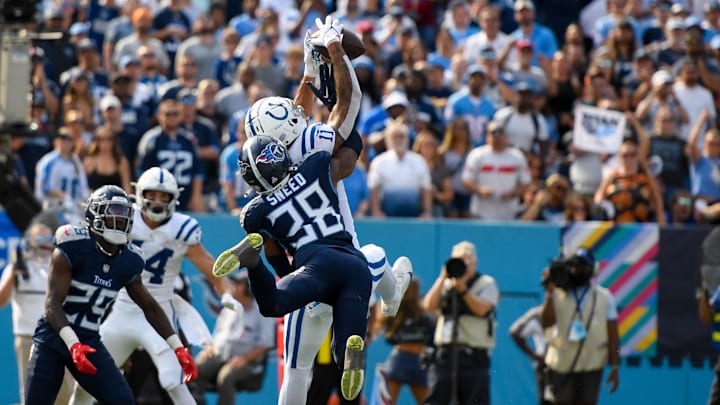 Oct 13, 2024; Nashville, Tennessee, USA;  Indianapolis Colts wide receiver Michael Pittman Jr. (11) makes a touchdown catch over Tennessee Titans cornerback L'Jarius Sneed (38) during the second half at Nissan Stadium. Mandatory Credit: Steve Roberts-Imagn Images