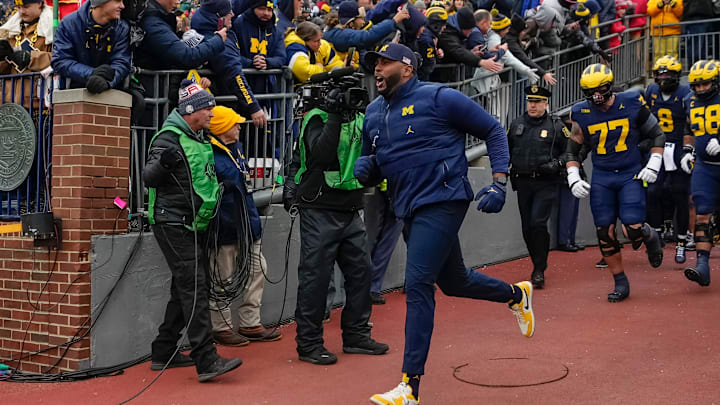 Michigan Wolverines head coach Sherrone Moore leads his team onto the field for warm ups during the NCAA football game against the Ohio State Buckeyes at Michigan Stadium in Ann Arbor, Mich. on Nov. 29, 2025. Ohio State won 27-9. Michigan Wolverines head coach Sherrone Moore leads his team onto the field for warm ups during the NCAA football game against the Ohio State Buckeyes at Michigan Stadium in Ann Arbor, Mich. on Nov. 29, 2025. Ohio State won 27-9.