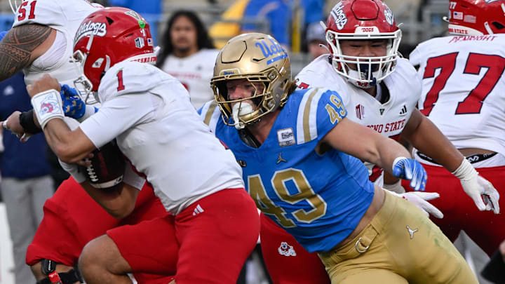 Nov 30, 2024; Pasadena, California, USA; UCLA Bruins linebacker Carson Schwesinger (49) sacks Fresno State Bulldogs quarterback Mikey Keene (1) during the second quarter at Rose Bowl. Mandatory Credit: Robert Hanashiro-Imagn Images