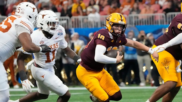 Arizona State quarterback Sam Leavitt (10) scrambles away from Texas linebacker Colin Simmons (11) during the second quarter of the Chick-fil-A Peach Bowl in Atlanta on Wednesday, Jan. 1, 2025. Arizona State quarterback Sam Leavitt (10) scrambles away from Texas linebacker Colin Simmons (11) during the second quarter of the Chick-fil-A Peach Bowl in Atlanta on Wednesday, Jan. 1, 2025.