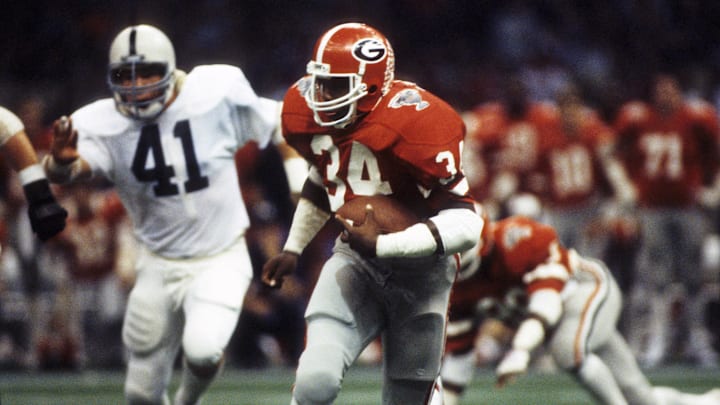 Jan 1, 1983, New Orleans, LA, USA; FILE PHOTO; Georgia Bulldogs running back Herschel Walker (34) pursued by Penn State Nittany Lions defensive end Steve Sefter (41) during the 1983 Sugar Bowl at the Superdome. Penn State defeated the bulldogs 27-23 to win the national championship. Mandatory Credit: Malcolm Emmons-Imagn Images