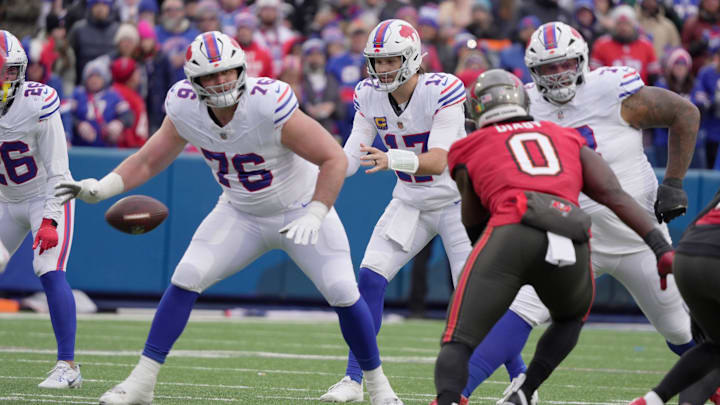 Tampa Bay Buccaneers linebacker Yaya Diaby heads towards Buffalo Bills quarterback Josh Allen who was just getting the snap during first half action against the Tampa Bay Buccaneers on Nov 16, 2025 at Highmark Stadium in Orchard Park. Guarding Allen are Buffalo Bills guard David Edwards and offensive tackle Dion Dawkins.