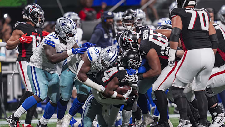 Atlanta Falcons wide receiver Ray-Ray McCloud III (34) is tackled by Dallas Cowboys defensive tackle Osa Odighizuwa (97) during the second half at Mercedes-Benz Stadium.