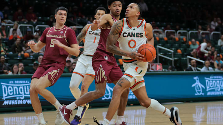 Jan 8, 2025; Coral Gables, Florida, USA; Miami Hurricanes guard Matthew Cleveland (0) drives to the basket against the Florida State Seminoles during the second half at Watsco Center. Mandatory Credit: Sam Navarro-Imagn Images