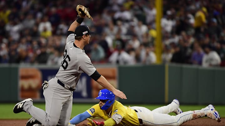 Jun 14, 2025; Boston, Massachusetts, USA; Boston Red Sox catcher Carlos Narvaez (75) safely slides into second base past the stage of New York Yankees second baseman DJ LeMahieu (26) during the fourth inning at Fenway Park. Mandatory Credit: Bob DeChiara-Imagn Images