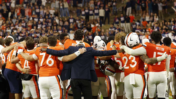 Oct 18, 2025; Charlottesville, Virginia, USA; Virginia Cavaliers players and staff sign the school song in font of the student sections after their game against the Washington State Cougars at Scott Stadium. Mandatory Credit: Geoff Burke-Imagn Images