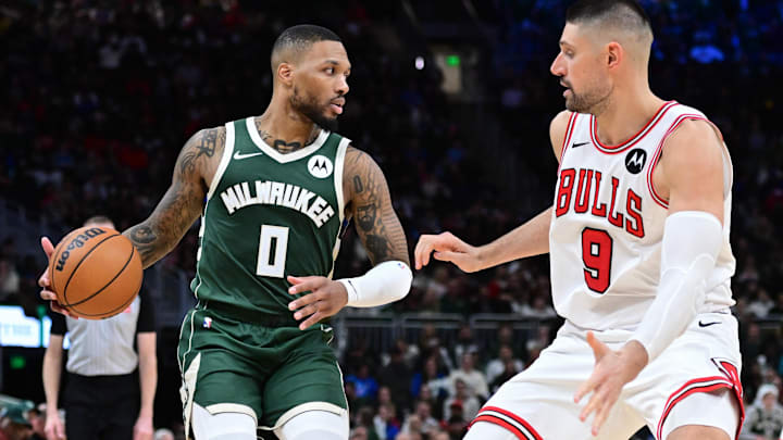 Nov 20, 2024; Milwaukee, Wisconsin, USA; Milwaukee Bucks guard Damian Lillard (0) drives against Chicago Bulls center Nikola Vucevic (9) in the fourth quarter at Fiserv Forum. Mandatory Credit: Benny Sieu-Imagn Images