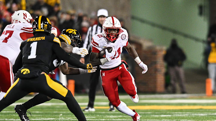 Nov 29, 2024; Iowa City, Iowa, USA; Nebraska Cornhuskers running back Emmett Johnson (21) runs the ball as Iowa Hawkeyes defensive back Xavier Nwankpa (1) moves in to make the tackle during the second quarter at Kinnick Stadium. Mandatory Credit: Jeffrey Becker-Imagn Images Nov 29, 2024; Iowa City, Iowa, USA; Nebraska Cornhuskers running back Emmett Johnson (21) runs the ball as Iowa Hawkeyes defensive back Xavier Nwankpa (1) moves in to make the tackle during the second quarter at Kinnick Stadium. Mandatory Credit: Jeffrey Becker-Imagn Images