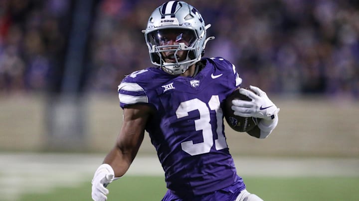 Nov 23, 2024; Manhattan, Kansas, USA; Kansas State Wildcats running back DJ Giddens (31) carries the ball during the fourth quarter against the Cincinnati Bearcats at Bill Snyder Family Football Stadium. Mandatory Credit: Scott Sewell-Imagn Images
