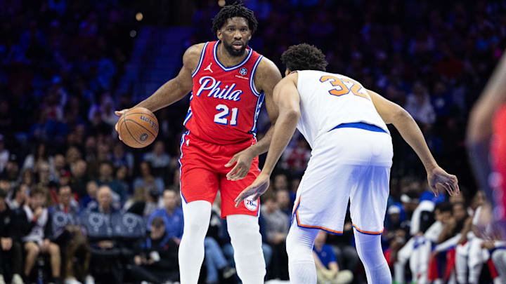 Nov 12, 2024; Philadelphia, Pennsylvania, USA; Philadelphia 76ers center Joel Embiid (21) dribbles the ball against New York Knicks center Karl-Anthony Towns (32) during the third quarter at Wells Fargo Center. Mandatory Credit: Bill Streicher-Imagn Images