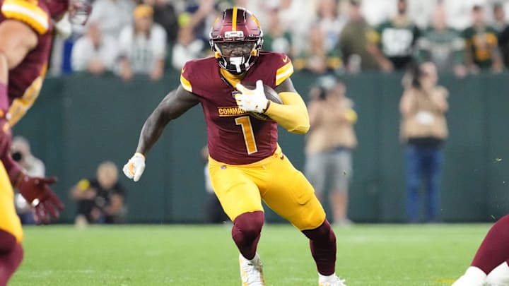 Sep 11, 2025; Green Bay, Wisconsin, USA; Washington Commanders wide receiver Deebo Samuel (1) runs against the Green Bay Packers in the second quarter at Lambeau Field. 