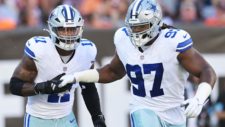 Dallas Cowboys stars Micah Parsons and Osa Odighizuwa celebrate after a sack against the Cleveland Browns.