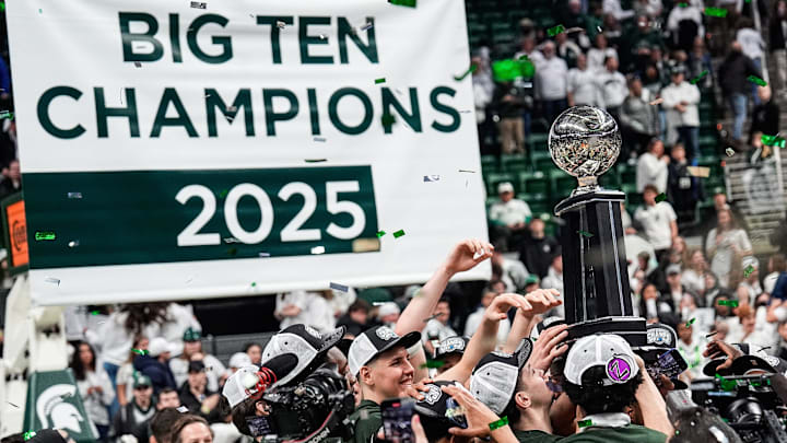 Michigan State basketball players celebrate their Big Ten regular season championships trophy after 79-62 win over Michigan at Breslin Center in East Lansing on Sunday, March 9, 2025.