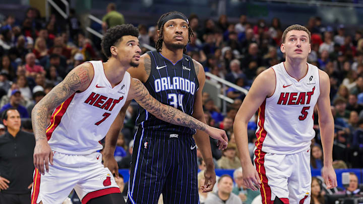 Orlando Magic center Wendell Carter Jr. (34), Miami Heat center Kel'el Ware (7) and forward Nikola Jovic (5) watch for the rebound during the second half at Kia Center.