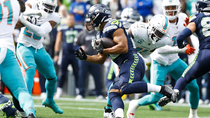 Seattle Seahawks running back Zach Charbonnet (26) rushes against the Miami Dolphins during the first quarter at Lumen Field. 
