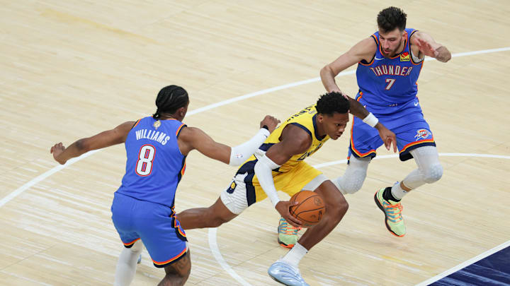 Jun 19, 2025; Indianapolis, Indiana, USA; Indiana Pacers guard Bennedict Mathurin (00) drives to the basket defended by Oklahoma City Thunder forward Jalen Williams (8) and forward Chet Holmgren (7) in the second quarter during game six of the 2025 NBA Finals at Gainbridge Fieldhouse. Mandatory Credit: Trevor Ruszkowski-Imagn Images