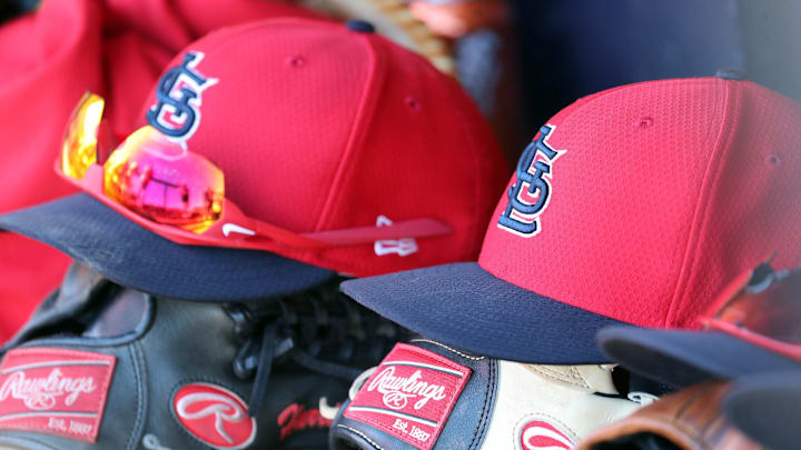 Mar 6, 2019; Tampa, FL, USA; St. Louis Cardinals hat and gloves lay in the dugout at George M. Steinbrenner Field. Mandatory Credit: Kim Klement-Imagn Images