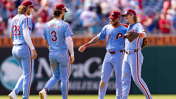 May 23, 2024; Philadelphia, Pennsylvania, USA; Philadelphia Phillies shortstop Edmundo Sosa (33) and Bryson Stott (5) celebrate with Bryce Harper (3) and Alec Bohm (28) after a victory against the Texas Rangers at Citizens Bank Park. Mandatory Credit: Bill Streicher-USA TODAY Sports