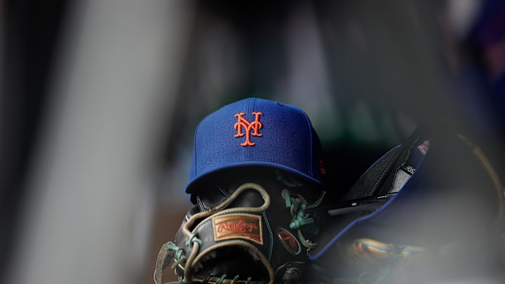 Aug 8, 2024; Denver, Colorado, USA; A New York Mets hat and glove in the dugout in the second inning against the Colorado Rockies at Coors Field. Mandatory Credit: Isaiah J. Downing-Imagn Images