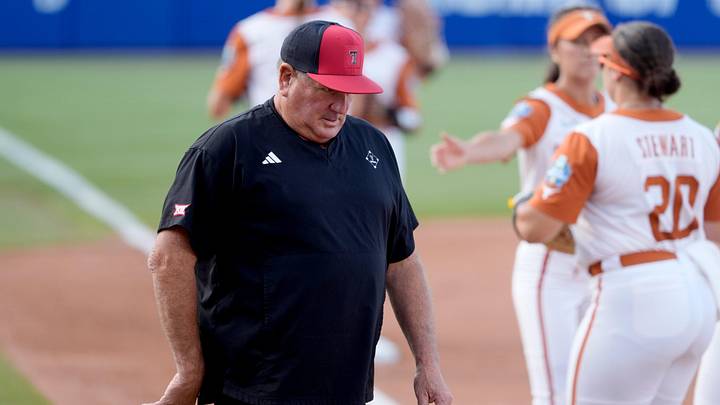 Texas Tech Red Raiders head coach Gerry Glasco walks back to the dugout after the first inning during Game 1 of the NCAA softball Women's College World Series finals between the Texas Longhorns and the Texas Tech Red Raiders at Devon Park in Oklahoma City, Wednesday, June 3, 2026.