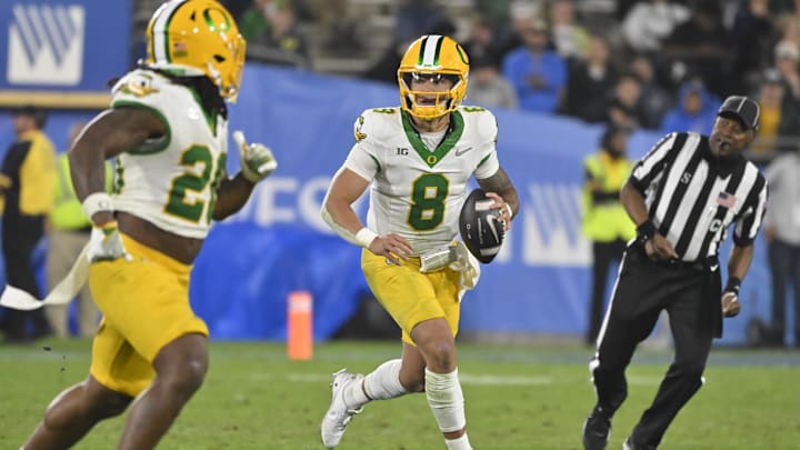Sep 28, 2024; Pasadena, California, USA; Oregon Ducks quarterback Dillon Gabriel (8) scrambles during the third quarter against the UCLA Bruins at Rose Bowl. Mandatory Credit: Robert Hanashiro-Imagn Images