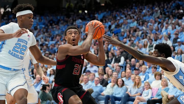 Jan 18, 2025; Chapel Hill, North Carolina, USA; Stanford Cardinal guard Jaylen Blakes (21) with the ball as North Carolina Tar Heels forward Ven-Allen Lubin (22) and guard Drake Powell (9) defend in the first half at Dean E. Smith Center. Mandatory Credit: Bob Donnan-Imagn Images