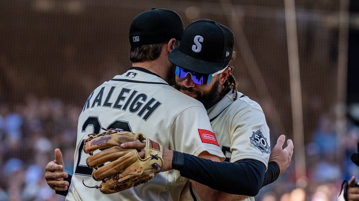 Sep 27, 2026; Seattle, Washington, USA;  Seattle Mariners shortstop J.P. Crawford (3) gets a hug from designated hitter Cal Raleigh (29) after leaving a game against the Los Angeles Angels during the fifth inning at T-Mobile Park. Mandatory Credit: Stephen Brashear-Imagn Images