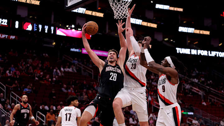 Nov 22, 2024; Houston, Texas, USA; Houston Rockets center Alperen Sengun (28) drives to the basket against Portland Trail Blazers center Donovan Clingan (23) during the first quarter at Toyota Center. Mandatory Credit: Erik Williams-Imagn Images