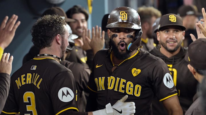San Diego Padres outfielder Fernando Tatis Jr. celebrates hitting a two-run home run in the dugout.