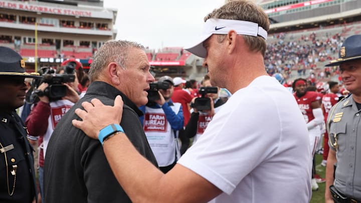 Arkansas Razorbacks head coach Sam Pittman shakes hands with Ole Miss Rebels head coach Lane Kiffin after the game at Donald W. Reynolds Razorback Stadium. Mississippi won 63-31. 