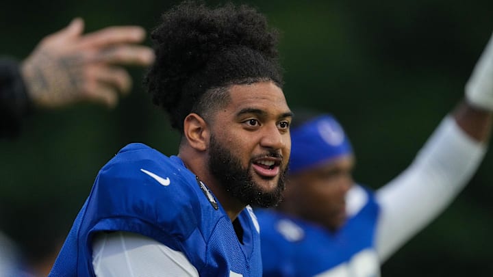 Indianapolis Colts defensive end JT Tuimoloau (91) sings while warming-up Thursday, July 31, 2025, during Colts Training Camp at Grand Park in Westfield. Indianapolis Colts defensive end JT Tuimoloau (91) sings while warming-up Thursday, July 31, 2025, during Colts Training Camp at Grand Park in Westfield.